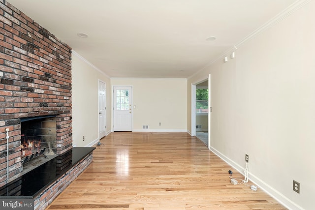 76 Stonicker Dr, Lawrence, NJ 08648 - unfurnished living room featuring light wood-style floors, a brick fireplace, healthy amount of natural light, and ornamental molding