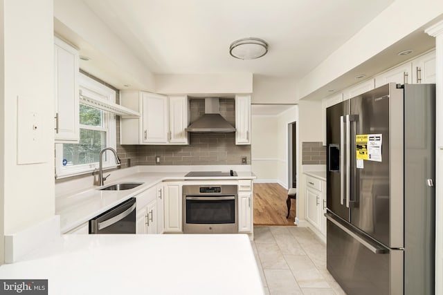 76 Stonicker Dr, Lawrence, NJ 08648 - kitchen featuring appliances with stainless steel finishes, wall chimney exhaust hood, light countertops, white cabinets, and backsplash