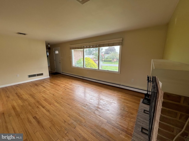 305 Reservoir Rd, Mechanicsburg, PA 17055 - unfurnished living room featuring baseboard heating and light wood finished floors