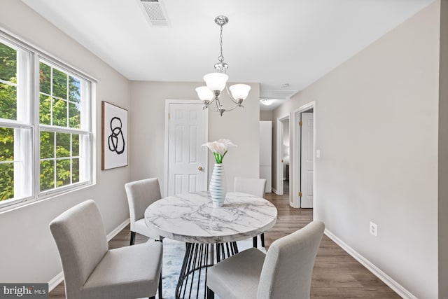 2050 N Calvert St Unit 410, Arlington, VA 22201 - dining area featuring a chandelier and wood finished floors