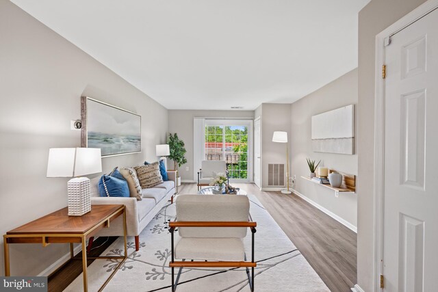 2050 N Calvert St Unit 410, Arlington, VA 22201 - living room featuring wood finished floors and baseboards