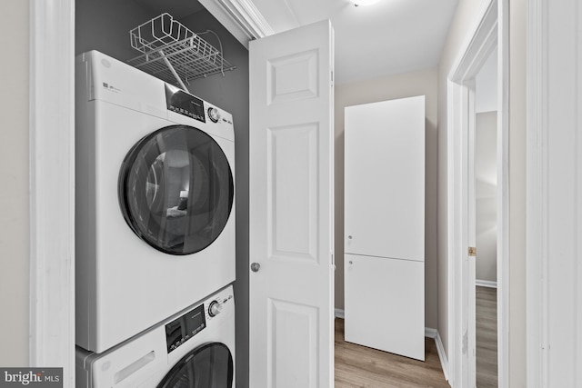 2050 N Calvert St Unit 410, Arlington, VA 22201 - laundry room featuring stacked washer / dryer and light wood-style floors