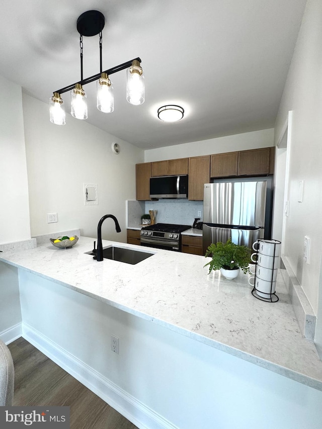 4141 N Henderson Rd Unit 1220, Arlington, VA 22203 - kitchen featuring appliances with stainless steel finishes, a peninsula, light stone countertops, dark wood-style flooring, and brown cabinets
