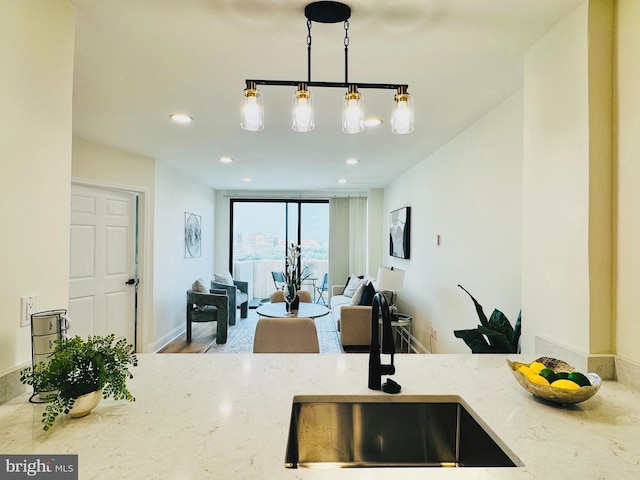 4141 N Henderson Rd Unit 1220, Arlington, VA 22203 - kitchen with light stone countertops, decorative light fixtures, and recessed lighting