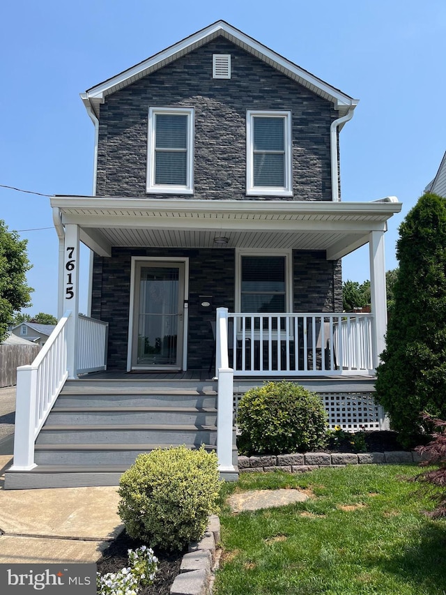 7615 Belmont Ave, Baltimore, MD 21224 - view of front facade featuring covered porch and stone siding