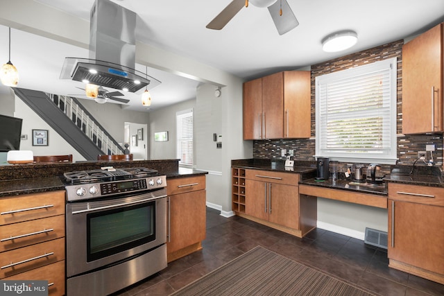 7615 Belmont Ave, Baltimore, MD 21224 - kitchen featuring stainless steel gas stove, island exhaust hood, ceiling fan, brown cabinets, and backsplash