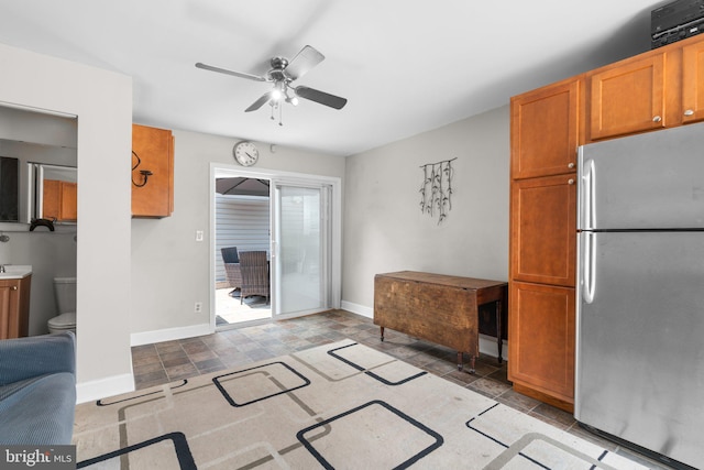 7615 Belmont Ave, Baltimore, MD 21224 - kitchen featuring freestanding refrigerator, ceiling fan, and brown cabinetry