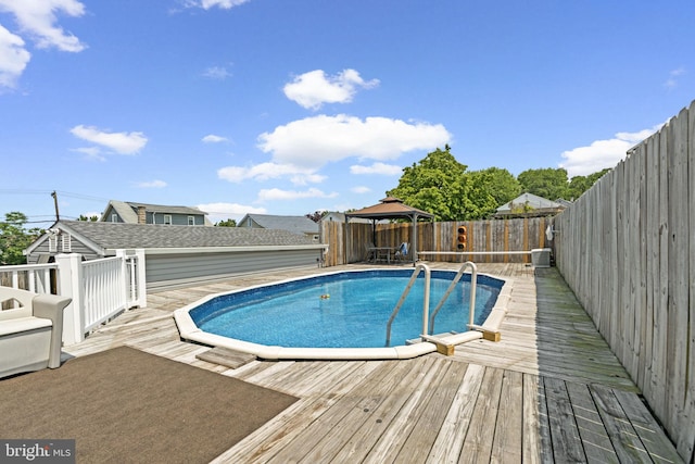 7615 Belmont Ave, Baltimore, MD 21224 - view of pool featuring a gazebo, a deck, and a fenced backyard