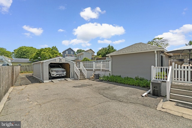7615 Belmont Ave, Baltimore, MD 21224 - view of parking / parking lot with a carport and stairs