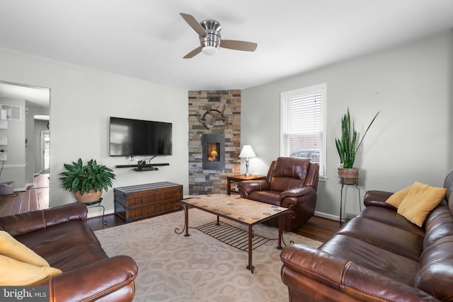 7615 Belmont Ave, Baltimore, MD 21224 - living area featuring ceiling fan, wood finished floors, and a stone fireplace