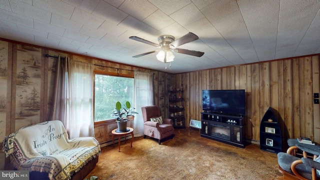 10495 Knobley Rd, Keyser, WV 26726 - living room featuring carpet flooring, ceiling fan, wood walls, and a baseboard radiator