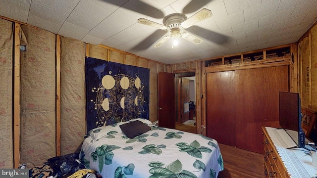 10495 Knobley Rd, Keyser, WV 26726 - bedroom with wood finished floors, wooden walls, and ceiling fan