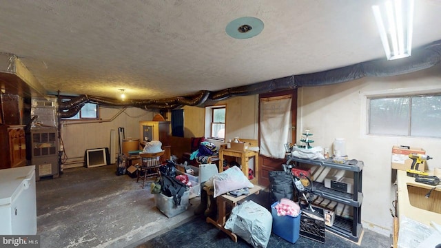 10495 Knobley Rd, Keyser, WV 26726 - basement featuring plenty of natural light, a textured ceiling, refrigerator, and heating unit
