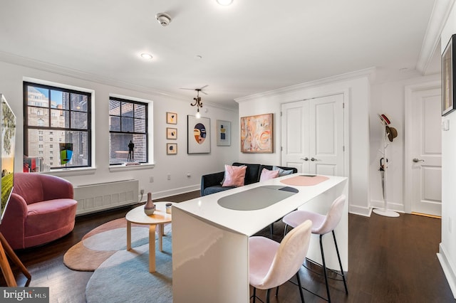 1701 Locust St Unit 1607, Philadelphia, PA 19103 - dining space featuring radiator, crown molding, dark wood-style floors, and recessed lighting