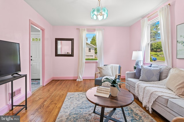 500 Maiden Choice, Catonsville, MD 21228 - living room featuring light wood finished floors, plenty of natural light, and a chandelier