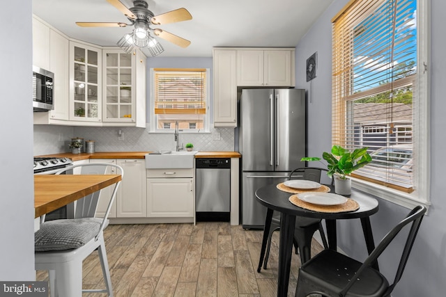 500 Maiden Choice, Catonsville, MD 21228 - kitchen with wood counters, appliances with stainless steel finishes, white cabinetry, and backsplash