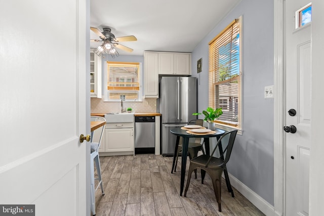 500 Maiden Choice, Catonsville, MD 21228 - kitchen with stainless steel appliances, tasteful backsplash, white cabinets, and light wood-style floors