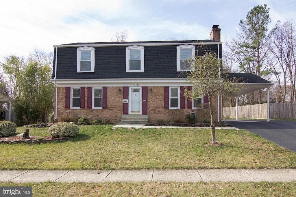 12008 Montague Dr, Laurel, MD 20708 - view of front facade featuring a shingled roof, a chimney, brick siding, mansard roof, and asphalt driveway