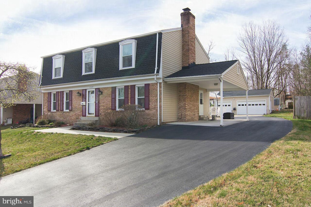 12008 Montague Dr, Laurel, MD 20708 - view of front facade featuring brick siding, a chimney, roof with shingles, and a front lawn