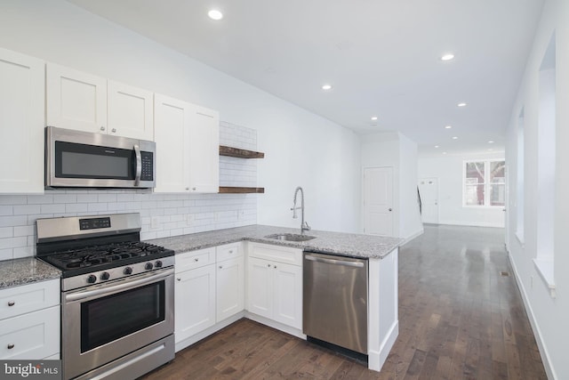 1737 N 28th St, Philadelphia, PA 19121 - kitchen featuring stainless steel appliances, open shelves, a peninsula, decorative backsplash, and white cabinetry