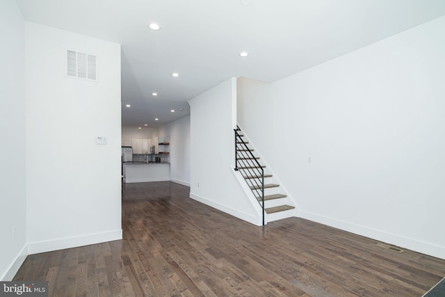 1737 N 28th St, Philadelphia, PA 19121 - unfurnished living room with dark wood-type flooring, stairway, and recessed lighting