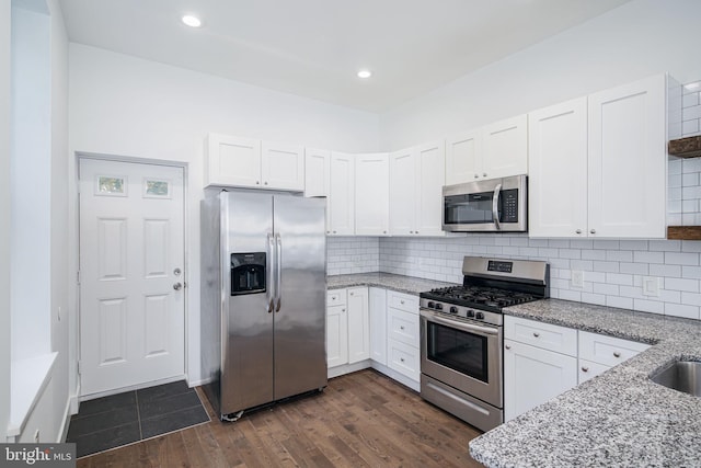 1737 N 28th St, Philadelphia, PA 19121 - kitchen with appliances with stainless steel finishes, white cabinetry, light stone counters, and recessed lighting