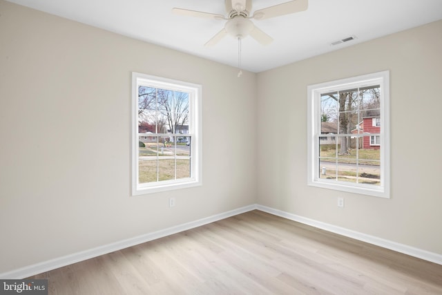 59 Parkside Cir, Willingboro, NJ 08046 - empty room with healthy amount of natural light, light wood finished floors, and a ceiling fan