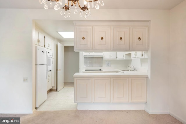 3360 Gleneagles Dr Unit 71-2B, Silver Spring, MD 20906 - kitchen featuring white appliances, exhaust hood, a peninsula, light carpet, and a chandelier