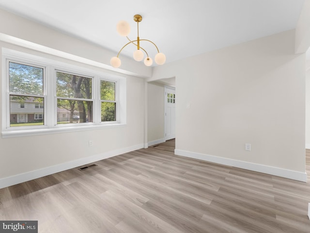 103 Hillcrest Ln, Willingboro, NJ 08046 - spare room featuring plenty of natural light, a chandelier, and light wood-style floors