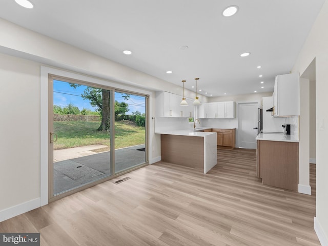 103 Hillcrest Ln, Willingboro, NJ 08046 - kitchen with light wood-style flooring, a peninsula, white cabinets, recessed lighting, and light countertops