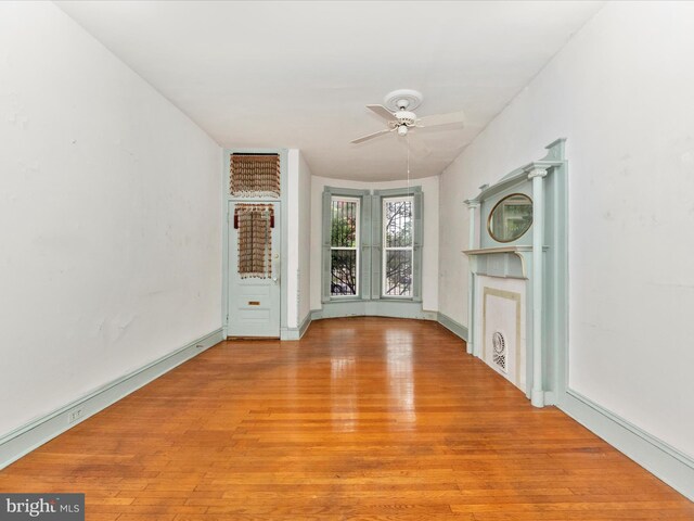 2700 Saint Paul St, Baltimore, MD 21218 - unfurnished living room featuring light wood-style flooring and a ceiling fan