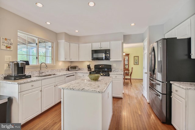 43076 Stonecottage Pl, Ashburn, VA 20147 - kitchen featuring black microwave, freestanding refrigerator, range, white cabinets, and recessed lighting