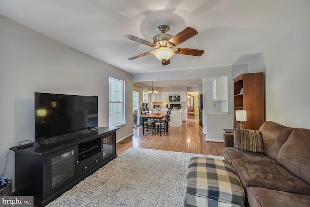 43076 Stonecottage Pl, Ashburn, VA 20147 - living area with ceiling fan, a chandelier, and light wood finished floors
