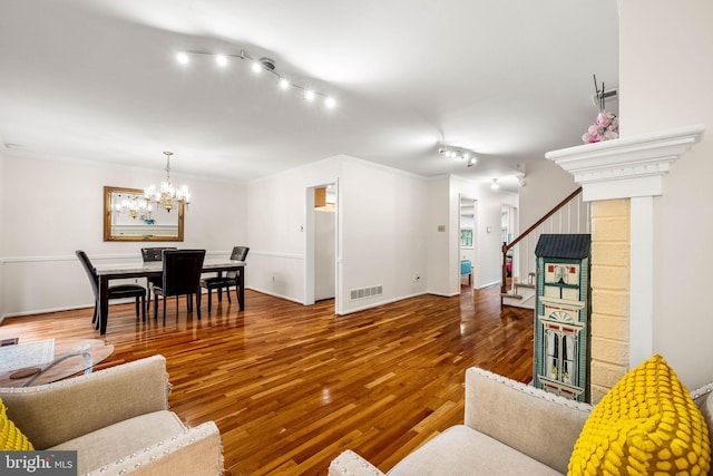 139 Putney Ln Unit 139, Malvern, PA 19355 - living room featuring rail lighting, stairway, a chandelier, wood finished floors, and ornamental molding