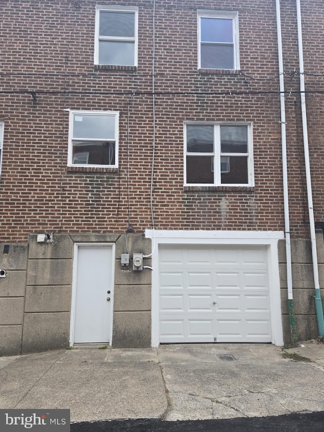 1531 Stevens St, Philadelphia, PA 19149 - back of property featuring brick siding, a garage, and driveway