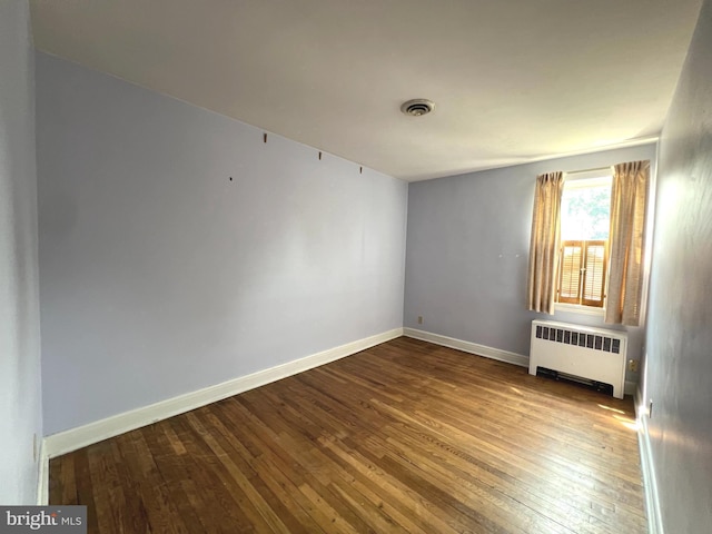 8544 Willow Oak Rd, Parkville, MD 21234 - spare room with radiator and hardwood / wood-style flooring