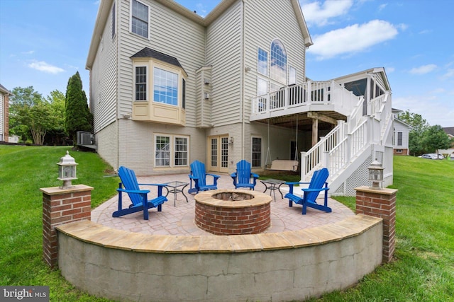 43146 Scenic Creek Way, Leesburg, VA 20176 - back of property featuring a fire pit, a patio area, a wooden deck, and a lawn
