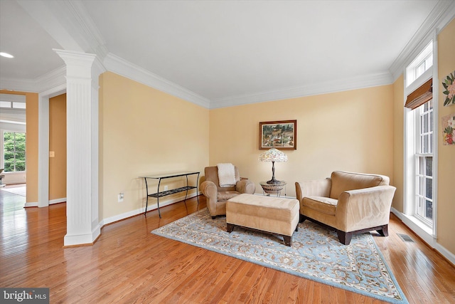 43146 Scenic Creek Way, Leesburg, VA 20176 - living area featuring ornate columns, wood finished floors, and ornamental molding
