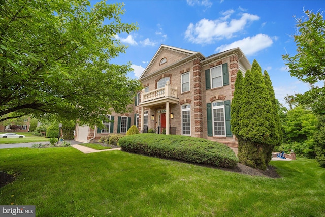 43146 Scenic Creek Way, Leesburg, VA 20176 - georgian-style home with brick siding, a front lawn, and a balcony