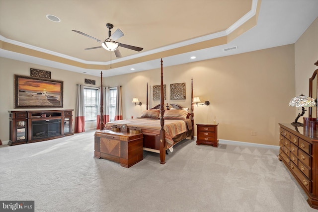 43146 Scenic Creek Way, Leesburg, VA 20176 - bedroom with a tray ceiling, light carpet, ornamental molding, recessed lighting, and a glass covered fireplace