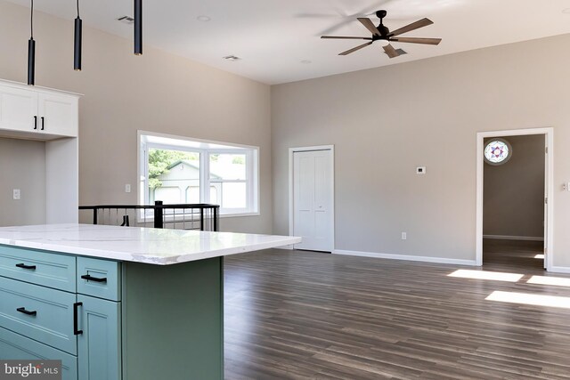 301 Nicholson Rd, Gloucester City, NJ 08030 - kitchen with dark wood-style floors, white cabinetry, ceiling fan, a towering ceiling, and light stone countertops