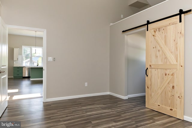301 Nicholson Rd, Gloucester City, NJ 08030 - spare room featuring a barn door and dark wood-style flooring