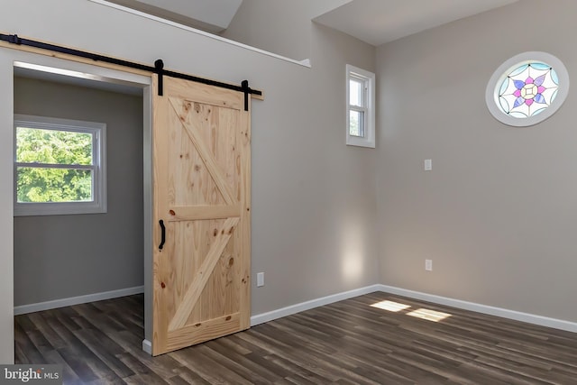 301 Nicholson Rd, Gloucester City, NJ 08030 - unfurnished room with a barn door, dark wood finished floors, and plenty of natural light