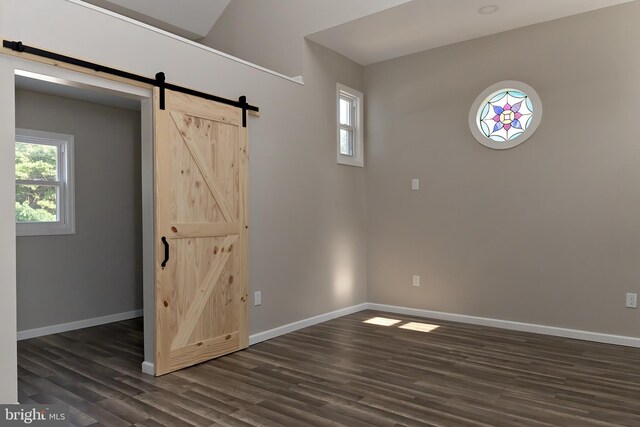 301 Nicholson Rd, Gloucester City, NJ 08030 - unfurnished room featuring a barn door and dark wood-type flooring