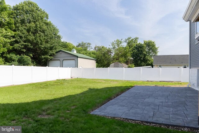 301 Nicholson Rd, Gloucester City, NJ 08030 - fenced backyard with a patio and a detached garage