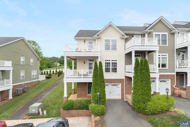 2126 Sundown Pl, Charlottesville, VA 22911 - view of front facade featuring a garage, brick siding, driveway, a balcony, and a front yard