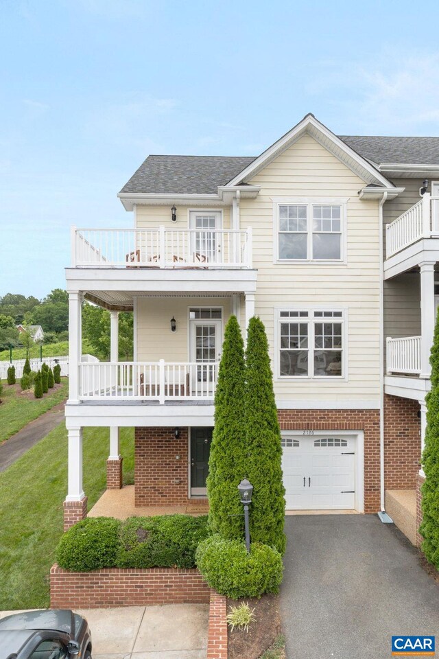 2126 Sundown Pl, Charlottesville, VA 22911 - view of front of property with a balcony, brick siding, an attached garage, driveway, and roof with shingles