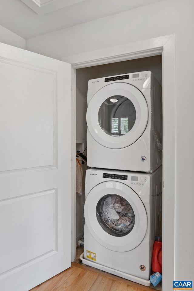2126 Sundown Pl, Charlottesville, VA 22911 - laundry area with estacked washer and dryer and wood finished floors
