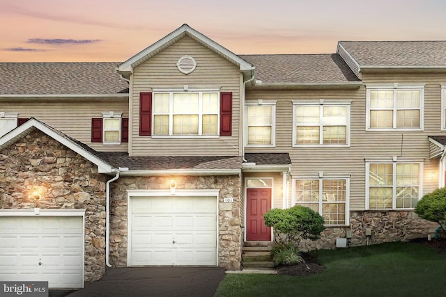404 Marion Rd, York, PA 17406 - townhome / multi-family property with stone siding, a shingled roof, and a garage