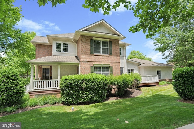 176 Windgate Dr, Chester Springs, PA 19425 - view of front of house with a front lawn, brick siding, a porch, and stucco siding